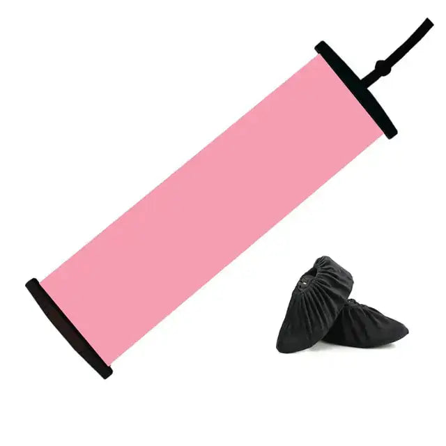 a pair of black shoes sitting next to a pink tube