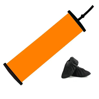 a pair of black shoes sitting next to an orange tube