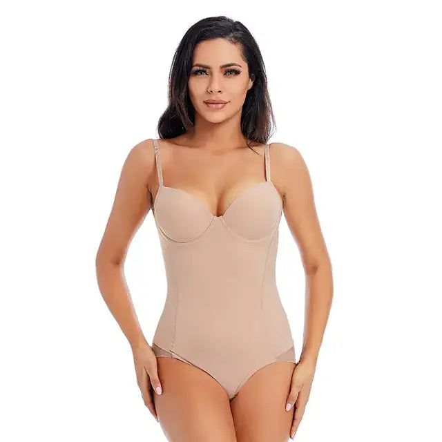 a woman in a nude bodysuit posing for the camera