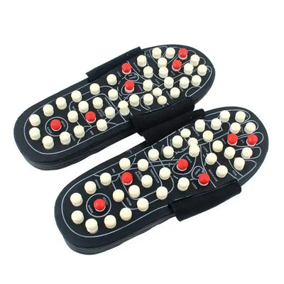 a pair of black and white shoes with red and white dots